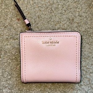 A light pink Kate Spade wallet brand new with tags